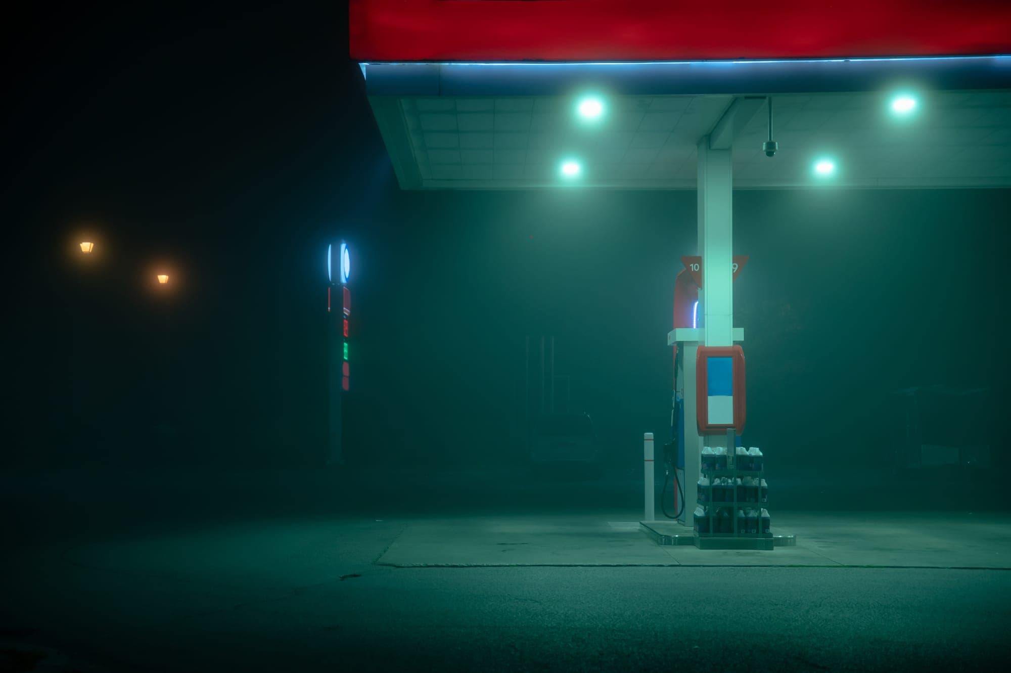 Gas pump at night shrouded in fog.