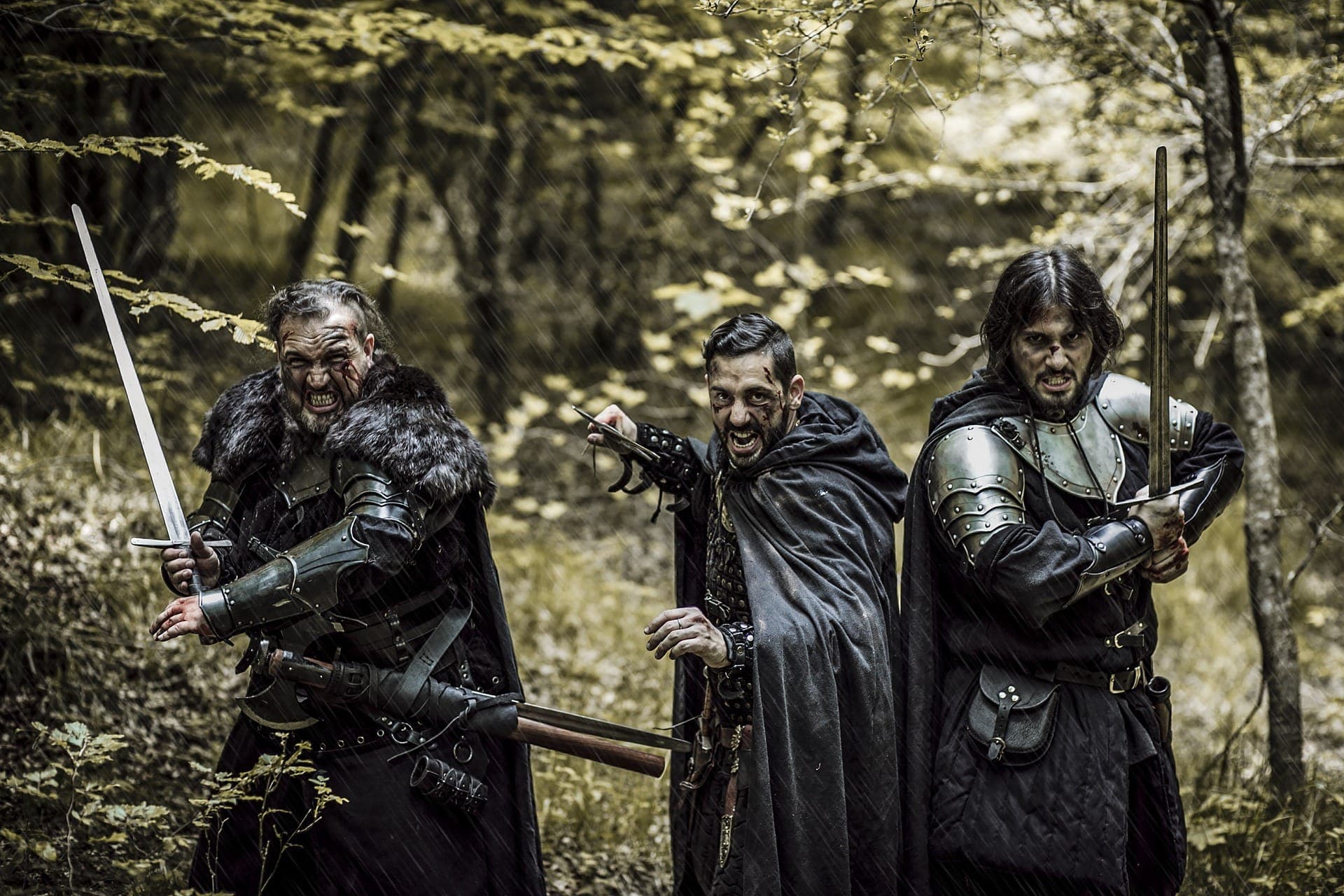 three men in knights armor looking like they're going to battle